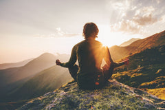 Man meditating yoga at sunset in the mountains | Mural