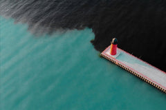 lighthouse in Milwaukee, with industrial water pollution in the bay